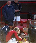 Beckham is treated for a calf injury against Arsenal