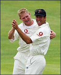 England colleagues Matthew Hoggard and Michael Vaughan celebrate the wicket of Virender Sehwag
