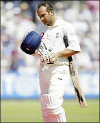 Mark Butcher walks back to the pavillion