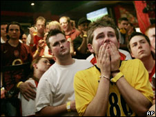 football fans watch football soccer ball game in pub