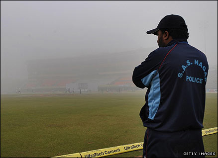 A Punjab police officer surveys a foggy scene