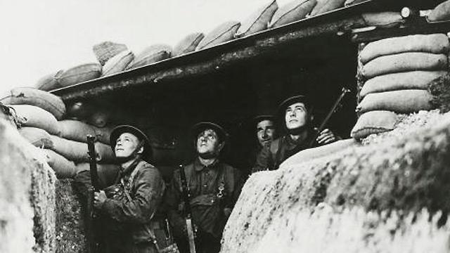 Soldiers at a defence post on the south-east coast anxiously watch German aircraft overhead on 1 August 1940.