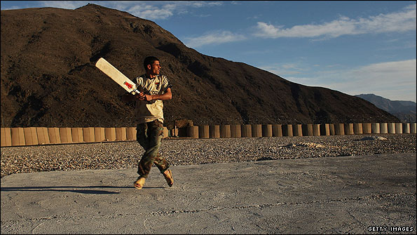 An Afghan solider playing cricket