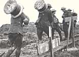 Royal Engineers taking drums of telephone wire along a duck board path up to the front between Pilckem and Langemarck, 10 October 1917
