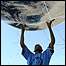 Man holding an Earth balloon