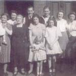 THE EMBARKATION PARTY. Back Row L to R: Aunt Elsie, uncle Charlie, cousin Jack (in uniform), Edna (his wife) and cousin Renee. Front Row L to R: cousin Frankie, Mum (holding cousin Jean) grandma Mary Jane Brass, aunt Katie (holding me) and cousin Elsie.