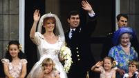 The Duke and Duchess of York stand waving on the balcony of Buckingham Palace on their wedding day, 23 July 1986.