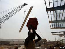 A worker at a Commonwealth Games stadium under construction in Delhi