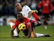 Pemain Bolton Wanderers Zat Knight menjatuhkan pemain Blackburn Rovers Jason Roberts. 
