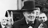 Winston Churchill giving his characteristic 'victory' sign on election day, 1945