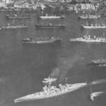 HMS Rajah is seen here off the stern, starboard quarter of the Battleship HMS King George V. The photograph was taken by one of the Rajah's aircraft while anchored in Colombo Harbour. (Photograph, Crown copyright).