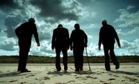 Veterans walking on a Normandy beach, 2004 (Photo: Mark Collins)