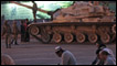 Hombres oran frente a tanques
