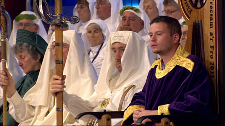 Rhys Iorwerth looks on.