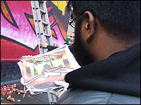 Ali checks the plans
