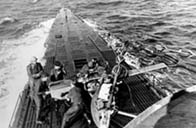 A German U-boat crew mans a deck gun during the Battle of the Atlantic