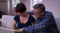 Stephen Fry and Aleks Krotoski looking at a computer