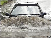 Car driving through flooded road