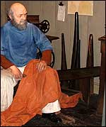Picture: A sailor mends his sails.