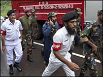 Soldiers of Pakistan Armed Forces rush to the site of a plane crash in Islamabad